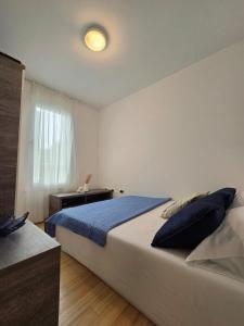 a bedroom with a large bed and a window at Apartman Oscar with pool access in Petrcane +25 photos