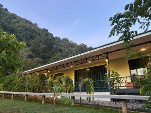 a building with a mountain in the background at The O' Khao Yai Mountain View Pool & Sauna Villa in Ban Tha Chang