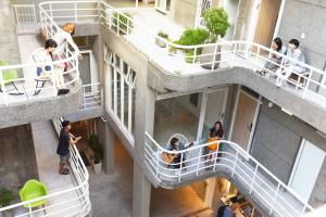 a group of people on stairs in a building at OwlStay Flip Flop Hostel - Garden in Taipei