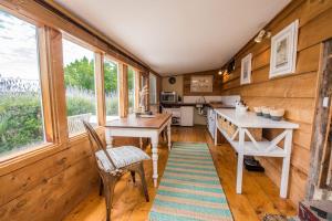 a kitchen with wooden walls and a table and chairs at Mrs Banks in Robe