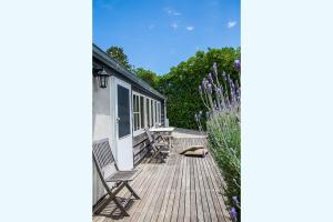 a deck with chairs and flowers on a house at Mrs Banks in Robe