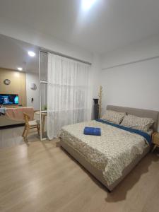 a bedroom with a bed and a living room at Mutiara Melaka Beach Resort in Kampong Pantai Dusun