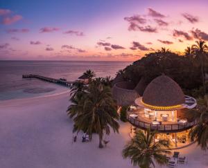 an aerial view of a resort on the beach at Kandolhu Maldives in Mushimasgali +54 photos
