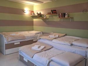 a room with four beds with towels on them at Kuca Kosta in Pale