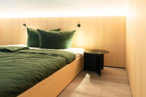 a small bedroom with a bed and a table at Ferienapartment OVIX in Okrug Donji