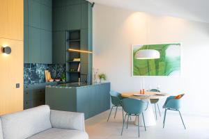 a kitchen with a table and chairs in a room at Ferienapartment OVIX in Okrug Donji