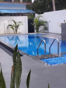 a swimming pool with two faucets in it at Coconut Villa in Arugam Bay