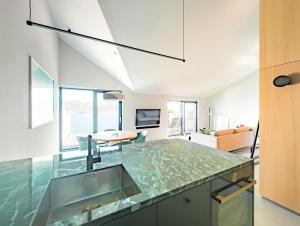 a kitchen with a sink and a living room at Ferienapartment OVIX in Okrug Donji