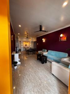 a living room with a blue couch and a table at Niyor Nest in Guwahati +11 photos