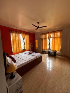 a bedroom with a bed and a ceiling fan at Niyor Nest in Guwahati