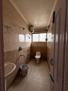 a bathroom with a sink and a toilet in it at Niyor Nest in Guwahati