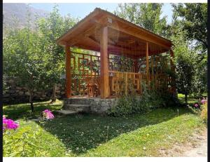 a wooden gazebo in the middle of a yard at Tem Hotel in Khorog