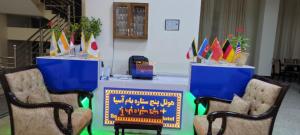 a table with two chairs and a table with a sign at Bam Asia Five Star Hotel in Bāmīān