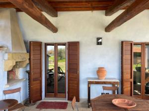 a kitchen with wooden doors and a table and a stove at Casina di Leonardo Arezzo in Arezzo