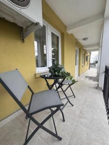 two chairs and a table next to a building at Vila Yzabelle in Eforie Nord +39 photos