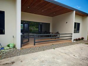 a porch of a house with a wooden roof at villa 911 in Pacific Harbour