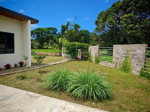 a yard with a fence and some plants at villa 911 in Pacific Harbour