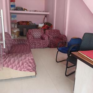 a living room with a couch and two chairs at Hotel welcome in Rīngas