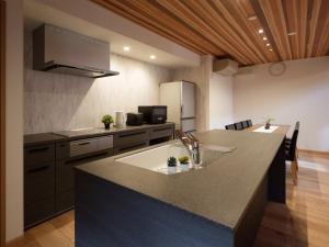 a kitchen with a large island with a counter top at マークヴィラ松本 in Matsumoto +17 photos
