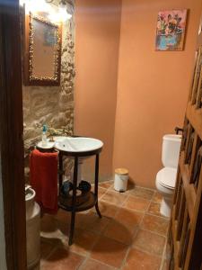 a bathroom with a sink and a toilet at Casa Rural Palacio Armiñón in Armiñón +19 photos