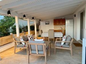 a patio with chairs and a table and a kitchen at Sunset House in Selçuk