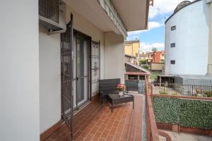 a balcony of a building with a bench on it at Casa Lella in Novara