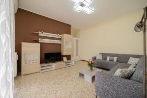 a living room with a couch and a tv at Casa Lella in Novara