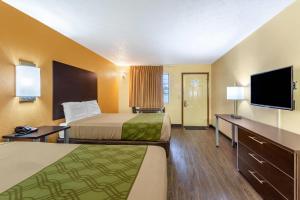 a hotel room with two beds and a flat screen tv at Econo Lodge Nashville North in Nashville