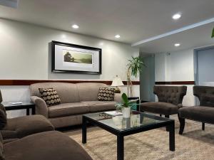 a living room with a couch and a table and chairs at Quality Inn & Suites Everett in Everett