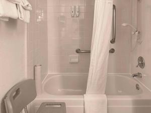 a bathroom with a white tub and a toilet at Quality Inn & Suites Everett in Everett
