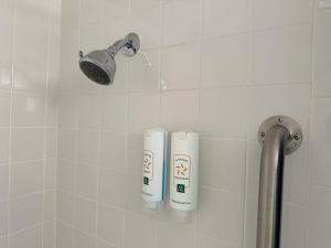 a shower with two rolls ofodorizers in a bathroom at Quality Inn & Suites Everett in Everett +52 photos