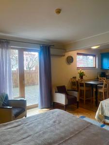 a bedroom with a bed and a table and a kitchen at Villa Meri Apartments in Pärnu