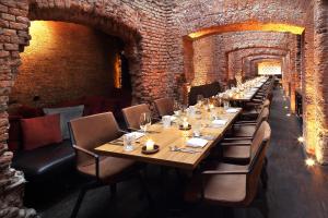 a long dining room with a long table and chairs at east Hotel Hamburg in Hamburg