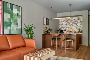 a living room with a couch and a table with chess at Skald Hotel Akureyri, Curio Collection By Hilton in Akureyri