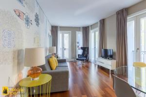 a living room with a couch and a tv at Cardosas Story Apartments by Porto City Hosts in Porto