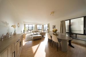 a kitchen and living room with a table and chairs at Spacious Apartment at Top Location Grote Markt in Sint-Niklaas