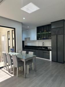a kitchen with a dining room table and chairs at The Perch House in Silañgang Mayao