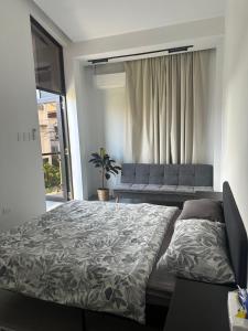 a bedroom with a bed and a couch at The Perch House in Silañgang Mayao
