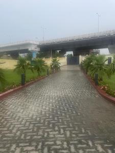 a cobblestone street with a bridge in the background at Vistara courtyard in Varanasi