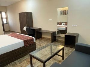 a hotel room with a bed and a table at Vistara courtyard in Varanasi