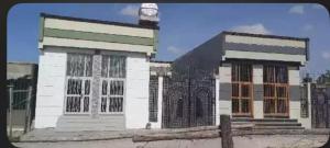 a building with a clock on top of it at dukan nahwi in Ursē