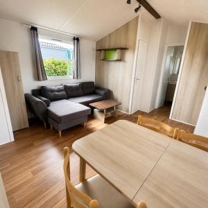 a living room with a couch and a table at Blueportel Horizon L40 in Le Portel