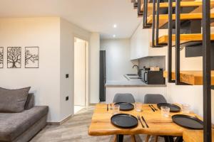 a living room with a table and chairs and a couch at Corfu nest apartment in Ágios Rókkos