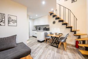 a living room with a couch and a table and a kitchen at Corfu nest apartment in Ágios Rókkos +19 photos