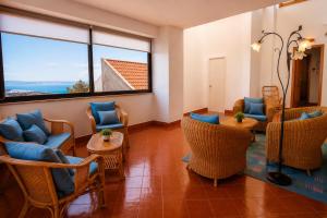 a waiting room with chairs and tables and a large window at Aloha Village - Bed&Pet in Messina