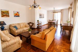 a living room with couches and a dining room at Aloha Village - Bed&Pet in Messina