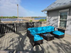 a patio with a blue bench and stool on a deck at Mrs Hippie Inn in Alma