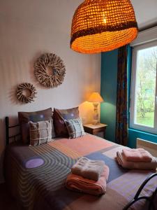 a bedroom with a bed with two towels on it at Chez Mikki in Cassaniouze