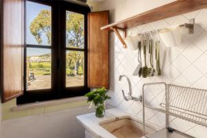 a bathroom with a sink and a window at Monte da Lagoa in Altura +196 photos