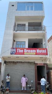 three people standing in front of a dream hotel at The Dream Hotel And Rooms in Etāwah